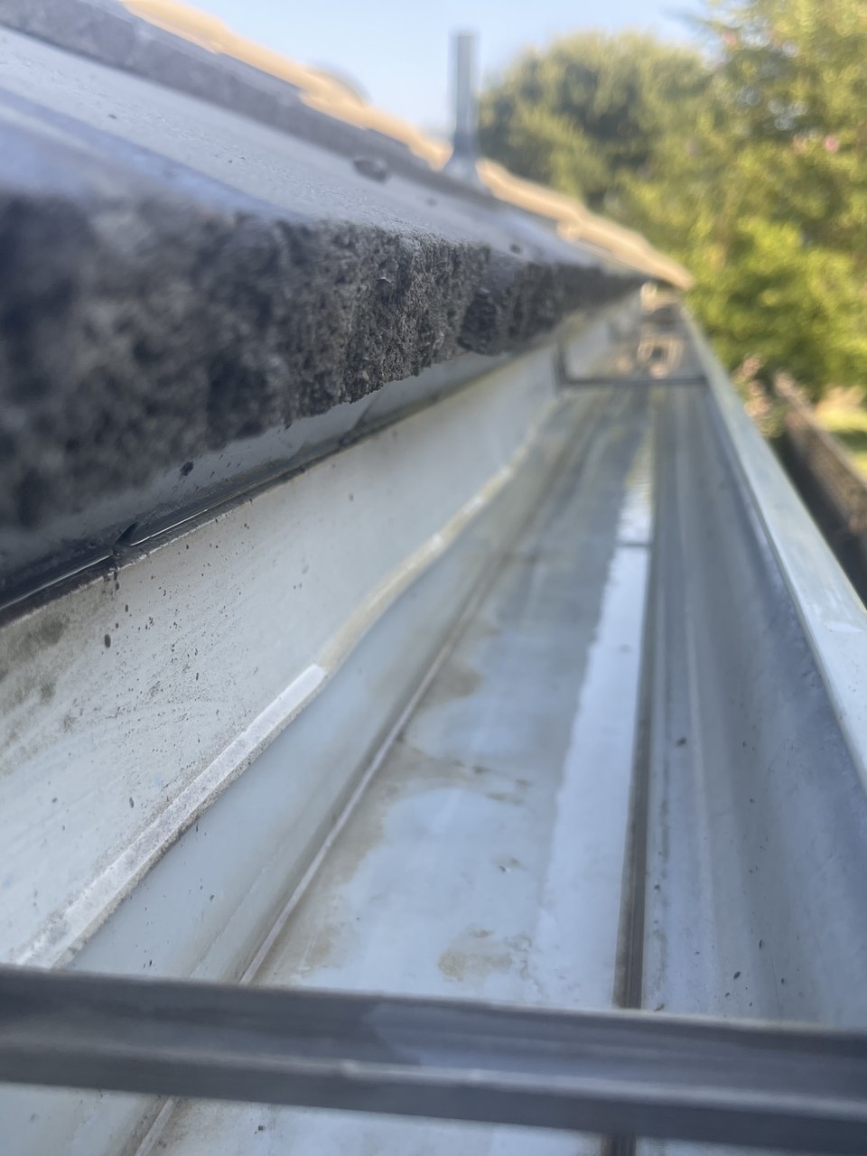 Cleaned and flushed gutters along a roofline on a Southern California home