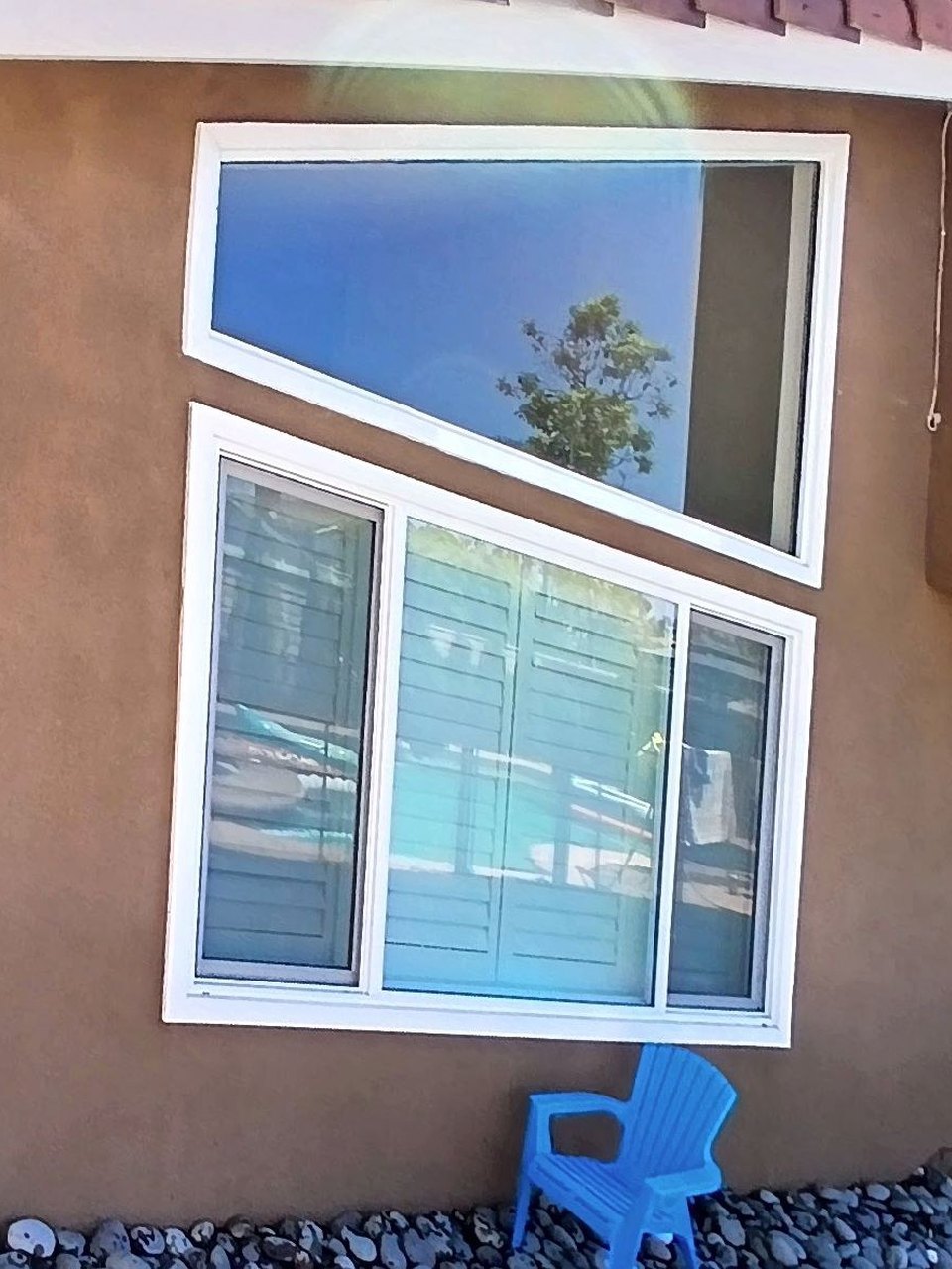 WashPro technician squeegee-cleaning a large beachfront window in Los Angeles
